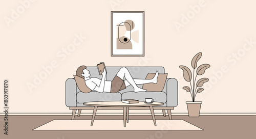 Man Relaxing Effortlessly Reading Book Lying Down on Sofa Couch in Modern Living Room with Potted Plant and Artwork on Wall at Home