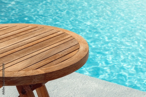 Wooden table beside a pool, sun-kissed water sparkles in a relaxing outdoor scene