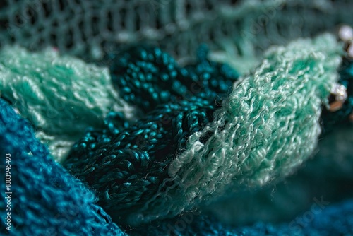 Closeup of various fabrics and gold beads.