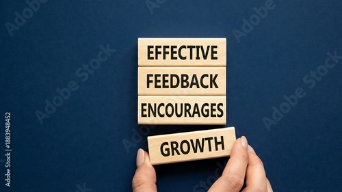 Feedback symbol. Wooden blocks with words Effective Feedback encourages growth. Businessman hand. Beautiful deep blue background. Business and Effective Feedback encourages growth concept