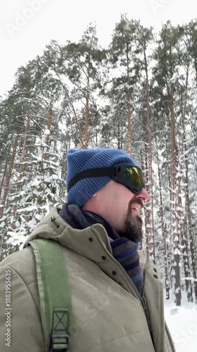 Mature Man Enjoying Silence of Winter Forest
