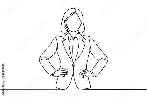 A confident businesswoman standing with her hands on her hips in a suit
