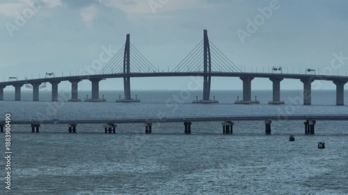 Wallpaper Mural Aerial time-lapse of the Hong Kong-Zhuhai-Macao Bridge, showcasing its serpentine form against dynamic skies, seamless traffic, and glowing artificial islands at dusk. Torontodigital.ca