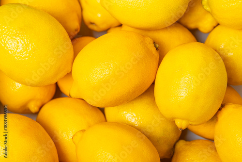 Lemon on a wooden table. Fresh lemon with a slice. Fresh lemon with citrus leaves. Lemon juice. Food and drink ingredients preparing. Healthy eating. Vitamin C. Space for text.