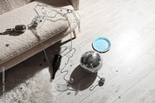 After party mess with disco balls and beads on floor in room