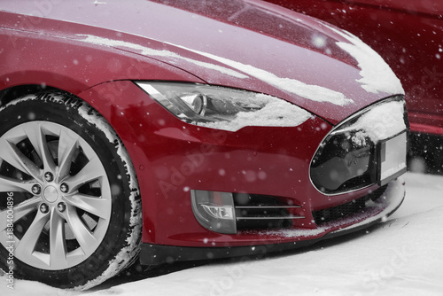 Red car with snow in city o...