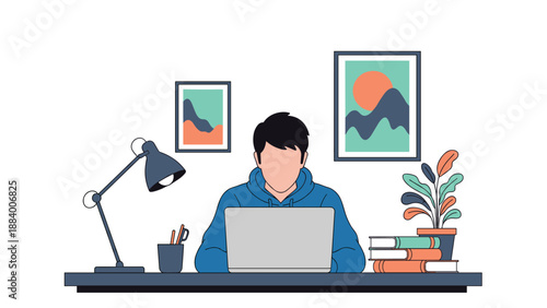 Young man in a blue hoodie sitting at a tidy desk working on his laptop in a home office decorated with plants and books.