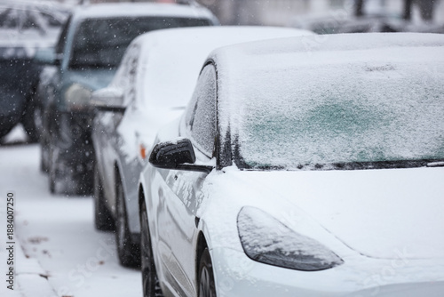 Cars covered with snow in c...