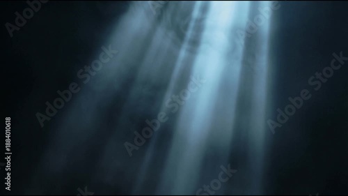 Volumetric light animation with cool blue gray rays descending through dark atmospheric space as soft mist drifts gently creating a calm cinematic and realistic visual mood