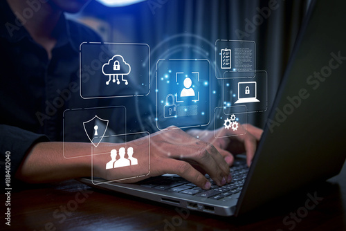 Business professional using laptop with holographic cybersecurity interface, digital shield, data protection icons, cloud security, and user authentication concept for modern technology and informatio