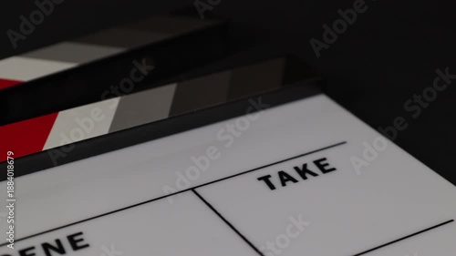 Elegant white clapperboard for modern cinema projects, isolated in a studio setup.