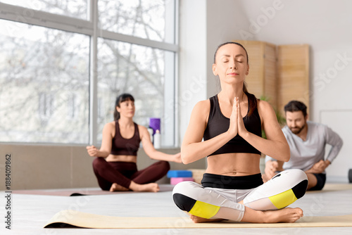 Sporty woman meditating on ...