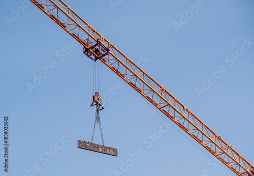 Photos The cargo is hanging under the boom of the tower crane.