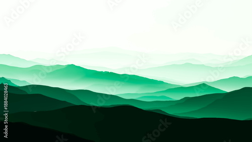 Misty blue mountain range landscape with clouds and fog over a scenic forest valley at sunrise dawn