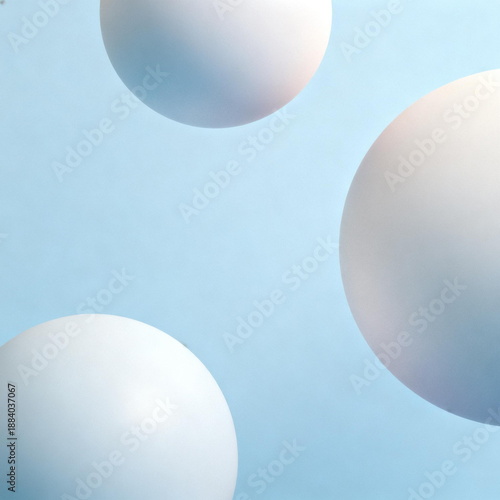 Three Pastel Colored Balls on Light Blue Background