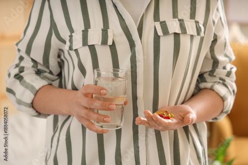Woman with pile of vitamin ...