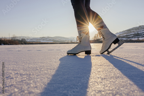 Woman ice-skating on a  frozen lake. 