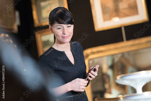 Photos female antique collector looking at the display