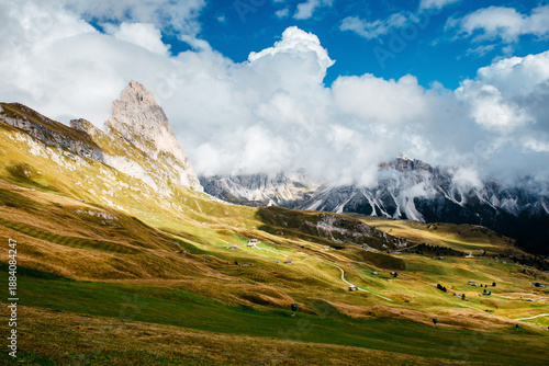 Seceda in the Dolomites with rolling green hills and dramatic clouds