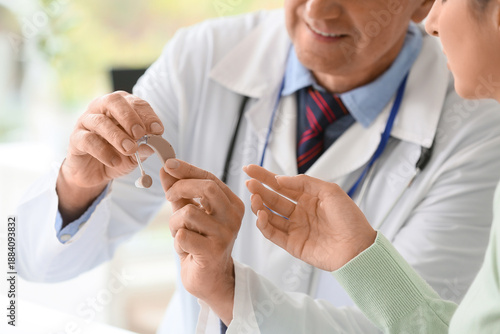Male doctor showing hearing...