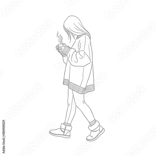 Young woman in oversized sweater holding a warm drink walking in winter.