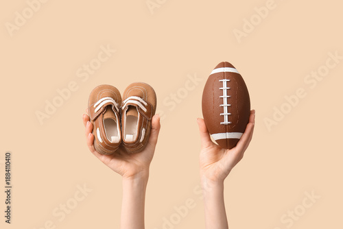 Hands holding baby booties ...