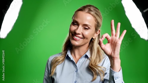 Smiling woman with blonde hair in a blue shirt giving 