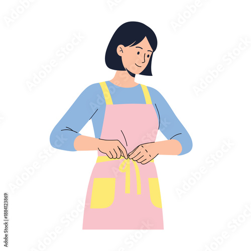 Woman tying kitchen apron while preparing to cook  