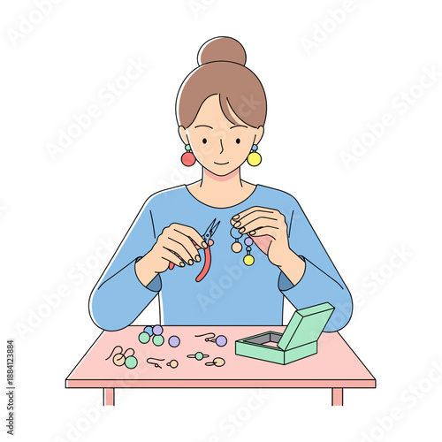 Young woman making handmade earrings while sitting at a table  