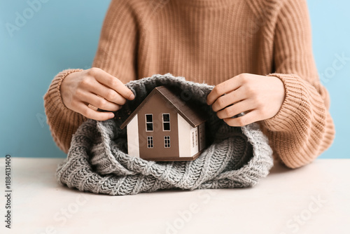 Woman with model of house a...