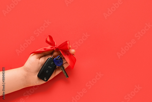 Female hand and gift keys o...