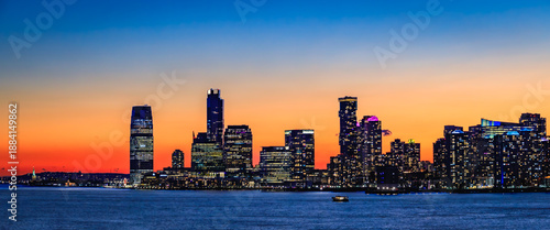 Jersey City skyline silhouette from New York, dramatic sunset over Hudson River