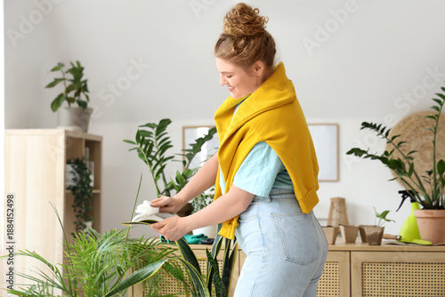 Young woman wiping green pl...