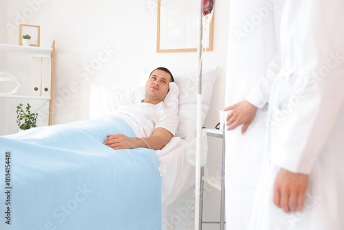 Male patient lying on bed w...