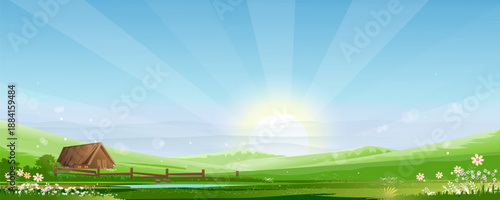 Landscape spring field,green nature with sun on blue sky in morning sunrise.Countryside rural with house cottage on hill, bloom flower,pond on grass land in summer.Beautiful bright light scenery farm