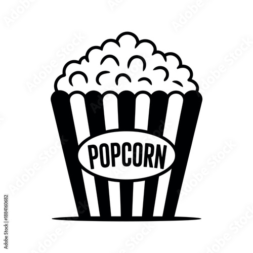 Classic black and white striped bucket filled with fluffy popcorn sits ready for movie night.