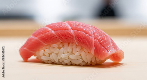 Delicious close-up of nigiri sushi with vibrant red tuna and perfectly seasoned rice, a quintessential Japanese delicacy.
