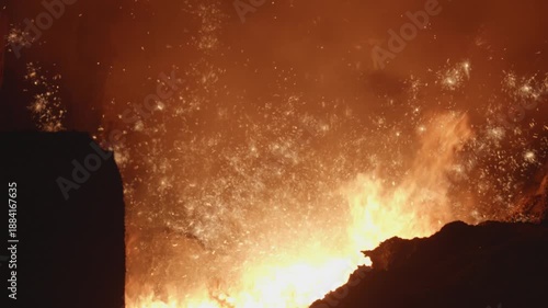 Molten iron ore pouring from industrial furnace