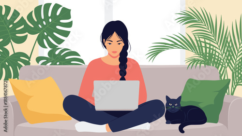 Young woman works comfortably on her laptop while sitting on a sofa next to a black cat and surrounded by lush green indoor plants.