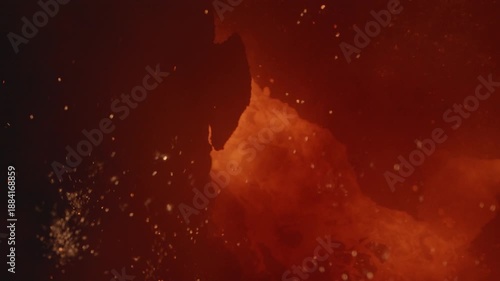 Molten iron liquid metal pouring from industrial furnace