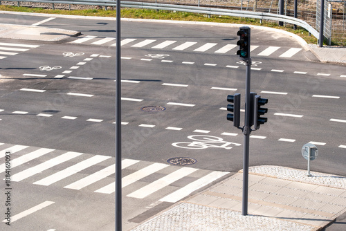 Overhead view of urban street intersection with crosswalk bicycle lanes markings and signal control supporting transport mobility and safer routing
