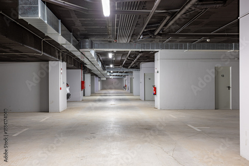 Spacious underground garage with storage rooms and ventilation ducts