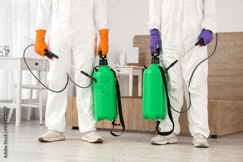 Male workers with disinfect...