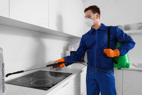 Male worker disinfecting in...