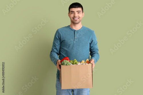 Young man with grocery bag ...