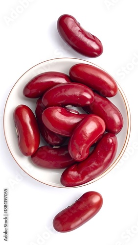 Overhead shot of red kidney beans in a small dish, isolated on white. Smooth, rounded shapes show a reddish hue