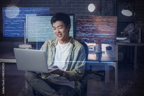 Male Asian programmer worki...