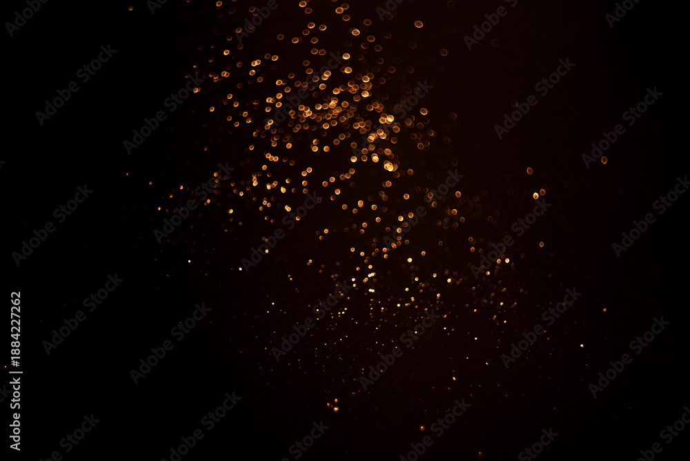 Fototapeta premium Golden abstract bokeh on black background.