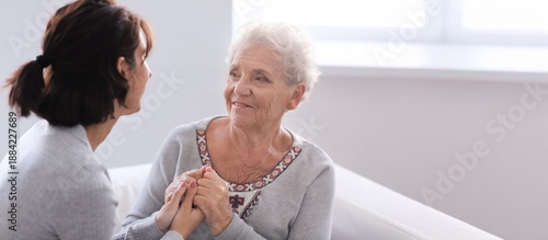 Happy elderly woman with he...