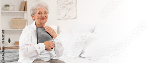 Senior woman with Bible sit...
